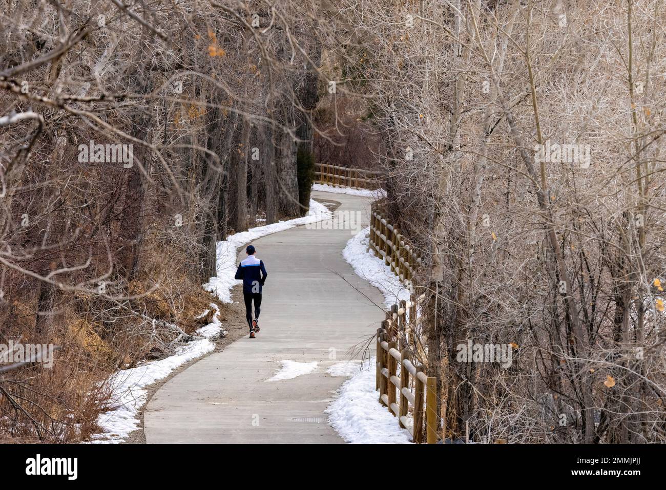 Runner on Clear Creek Trail in winter. Golden, Colorado, USA Stock Photo
