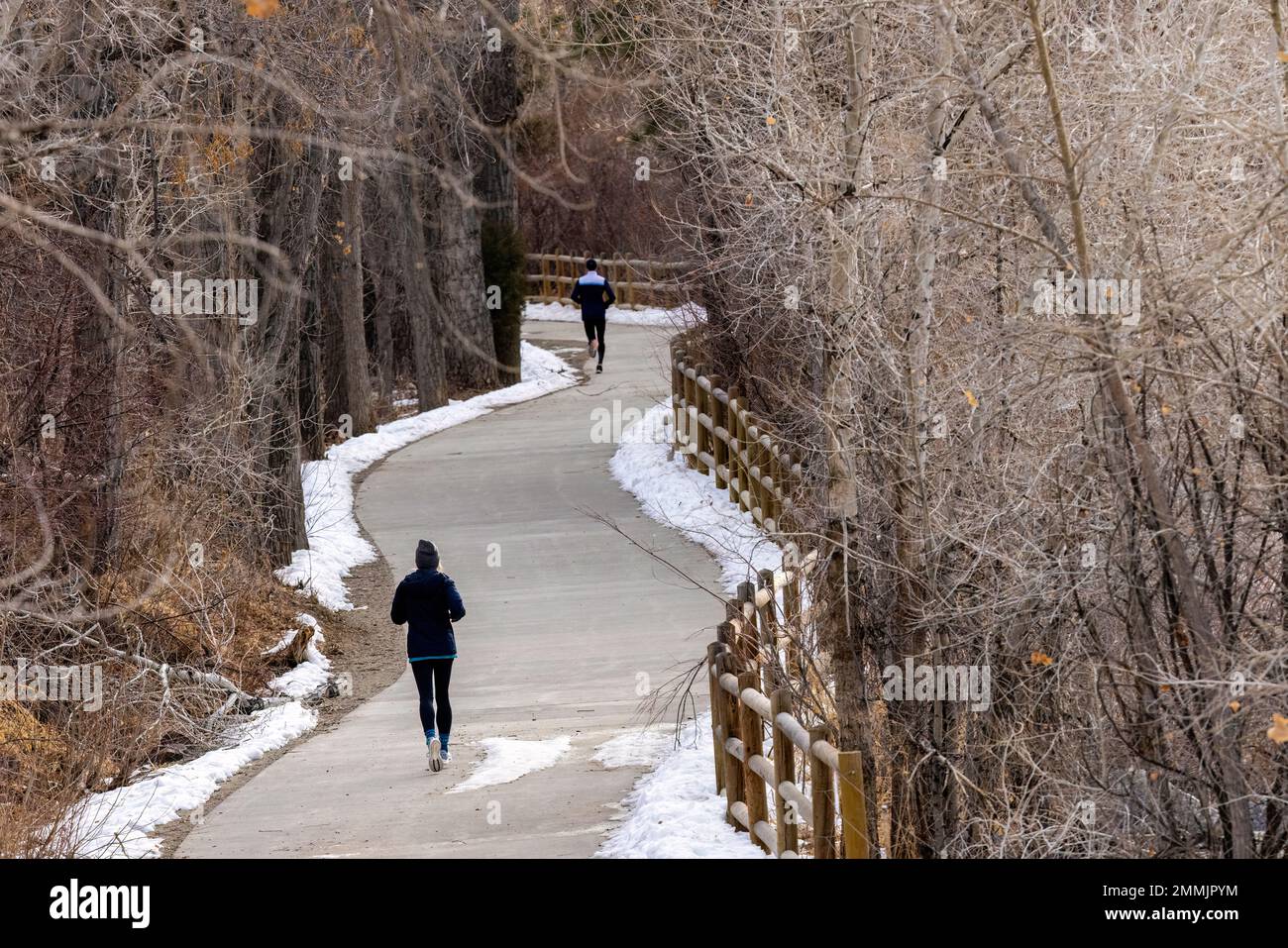 Runners on Clear Creek Trail in winter. Golden, Colorado, USA Stock Photo