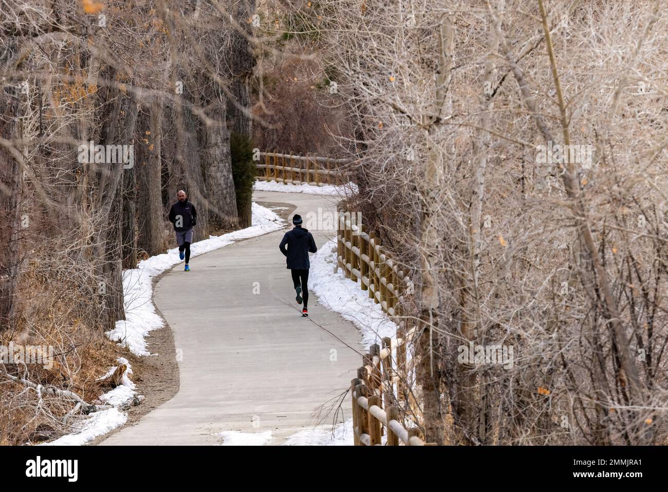 Runners on Clear Creek Trail in winter. Golden, Colorado, USA Stock Photo