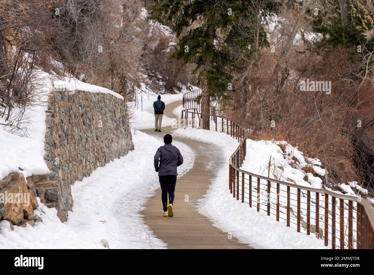 People exercsing on Peaks to Plains Trail in Clear Creek Canyon in winter. Golden, Colorado, USA Stock Photo