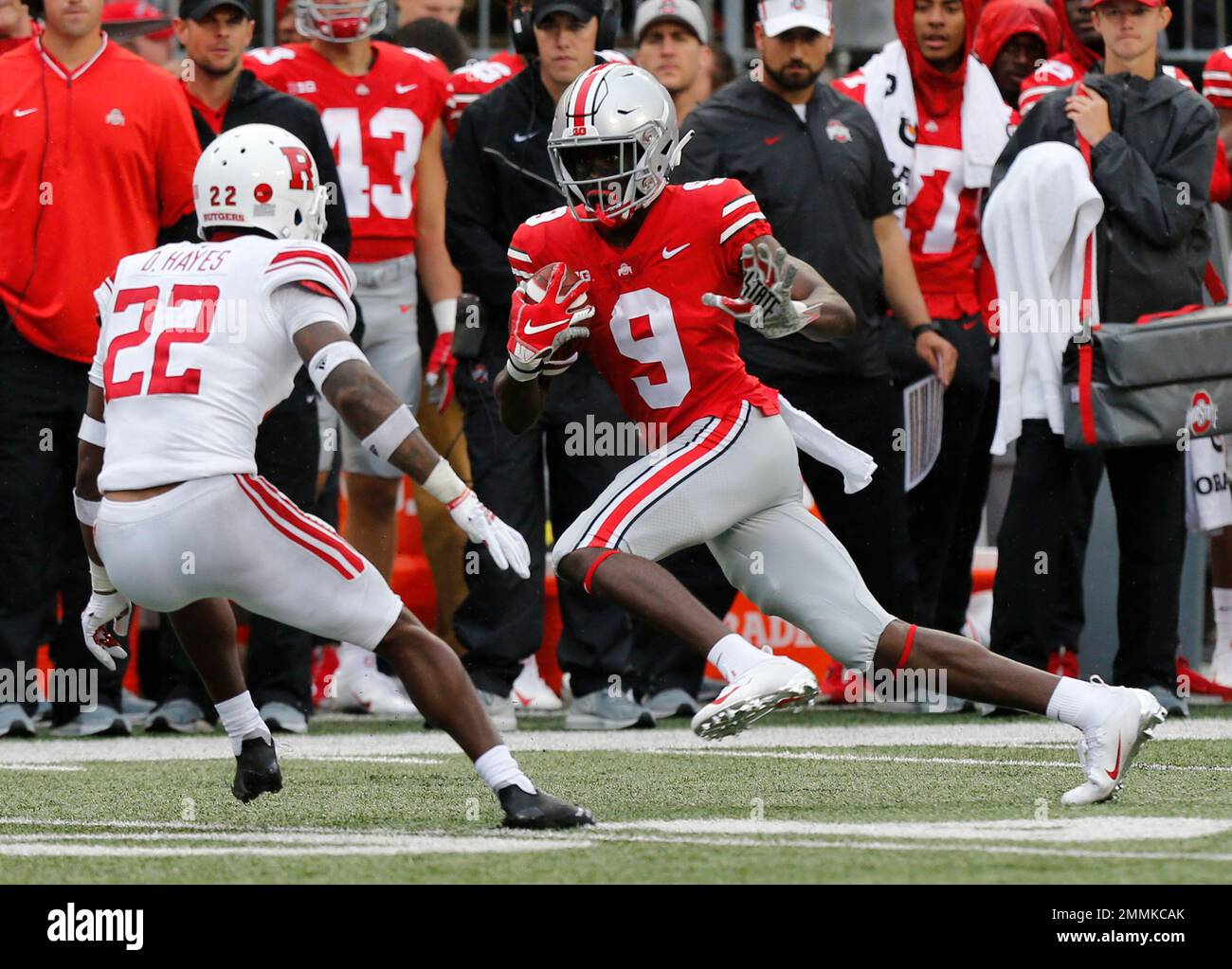 Ohio State receiver Binjimen Victor, right, tries to avoid Rutgers