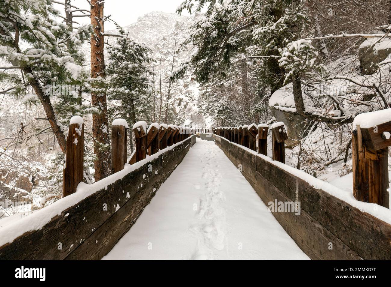 Snow-covered old wooden flume on Welch Ditch Trail in Clear Creek Canyon in winter. Part of the Peaks to Plains Trail - near Golden, Colorado, USA Stock Photo