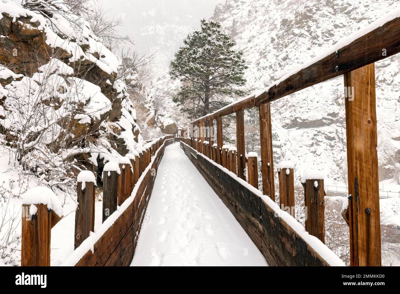 Snow-covered old wooden flume on Welch Ditch Trail in Clear Creek Canyon in winter. Part of the Peaks to Plains Trail - near Golden, Colorado, USA Stock Photo