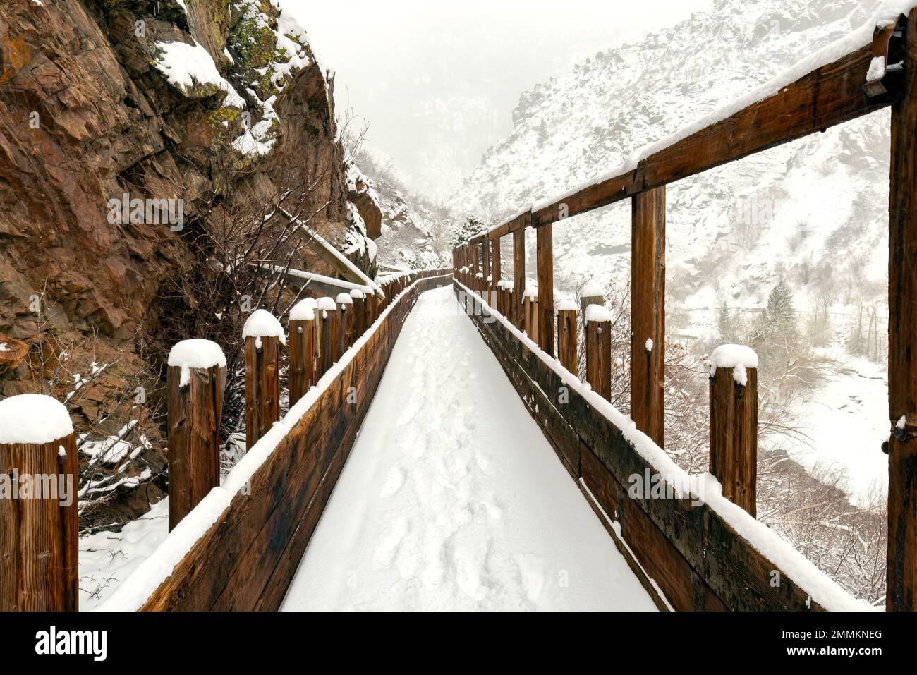 Snow-covered old wooden flume on Welch Ditch Trail in Clear Creek Canyon in winter. Part of the Peaks to Plains Trail - near Golden, Colorado, USA Stock Photo
