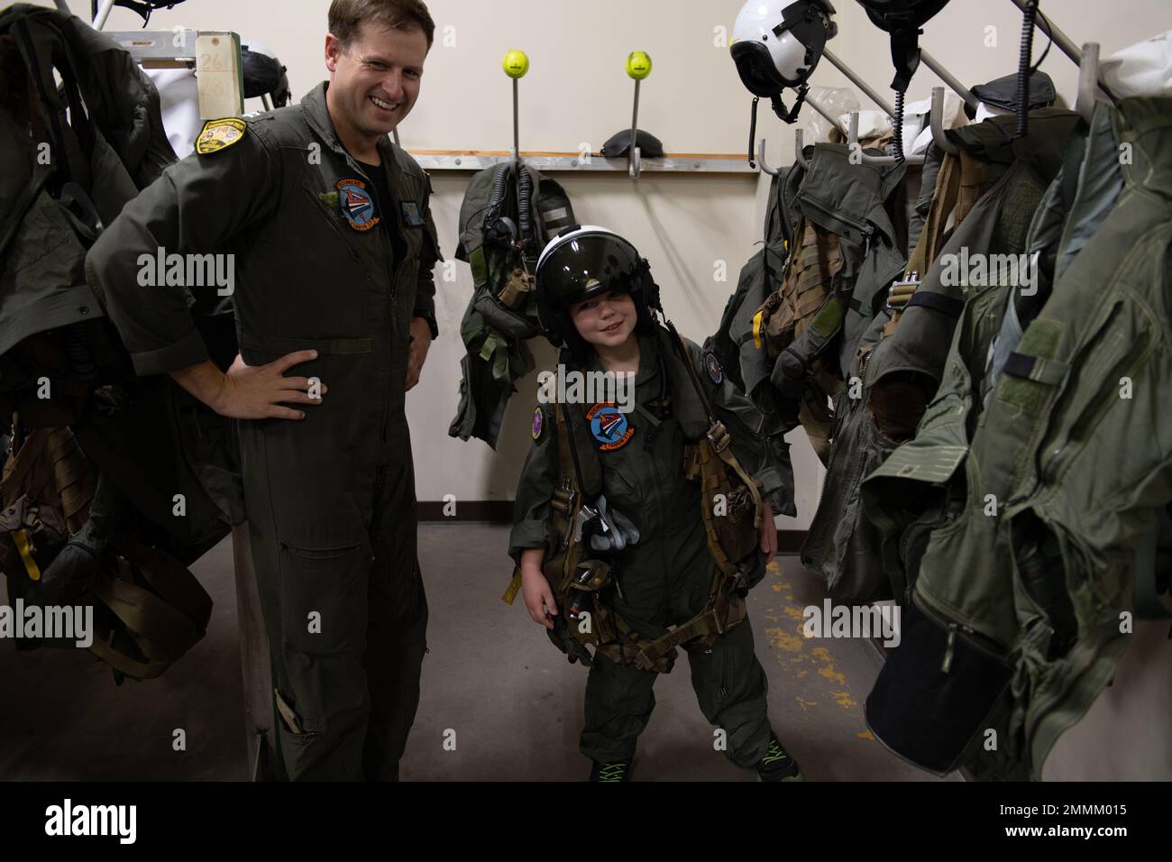 Seth Wilkey, Pilot for a Day, wears a Naval Aviator helmet and survival vest with Lieutenant James Lowe in the VT-28 Paraloft on Naval Air Station Corpus Christi, Sept. 20. Pilot for a Day is a public outreach program between Training Squadron 35 and Driscoll Children's Hospital where children experience a day in the life of a Naval Aviator. Stock Photo