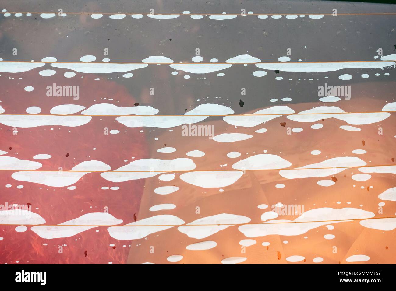 Close up to rear window of car with bubbles on glass very poor