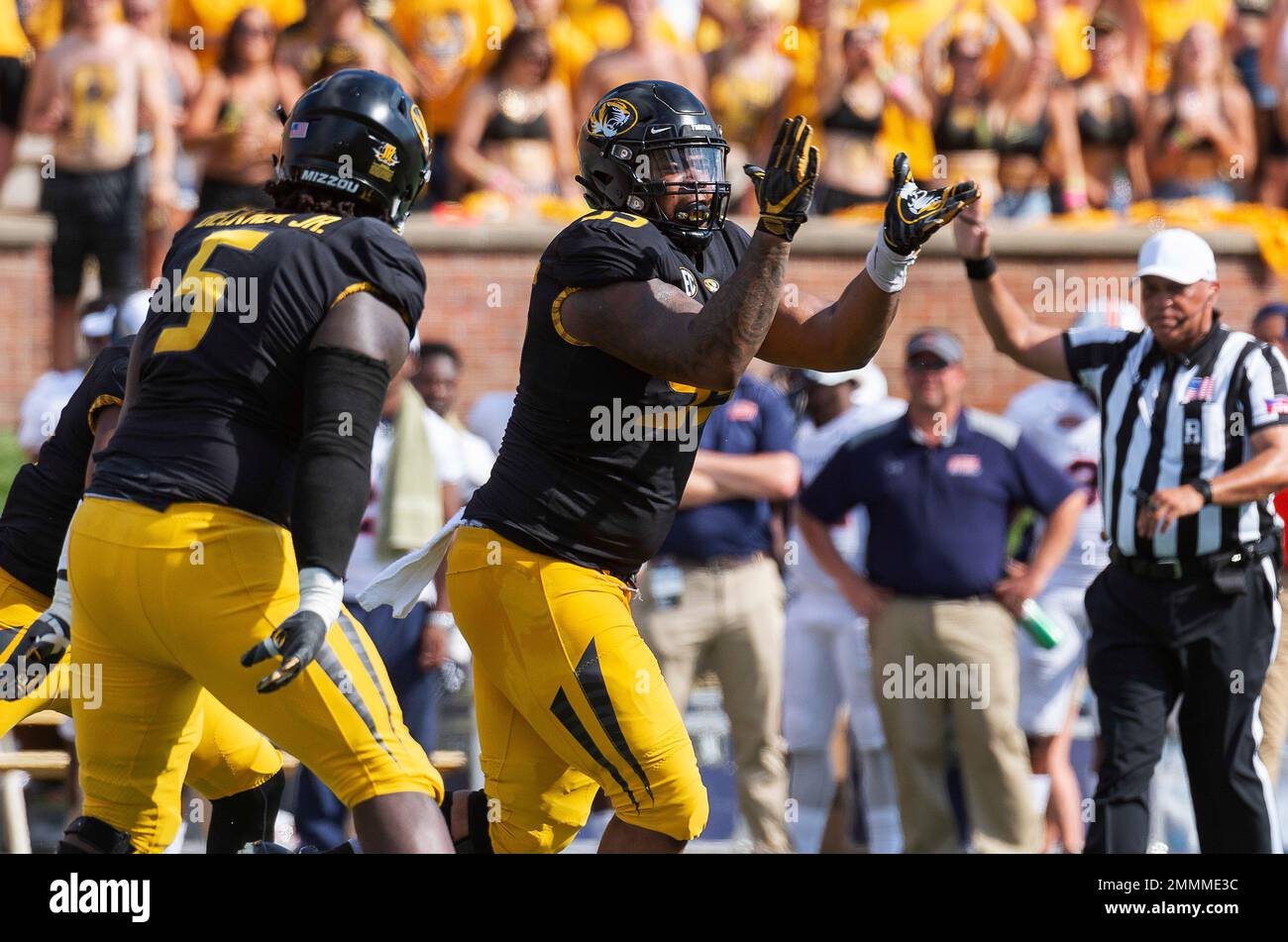 Missouri defensive lineman Jordan Elliott, right, celebrates a sack of