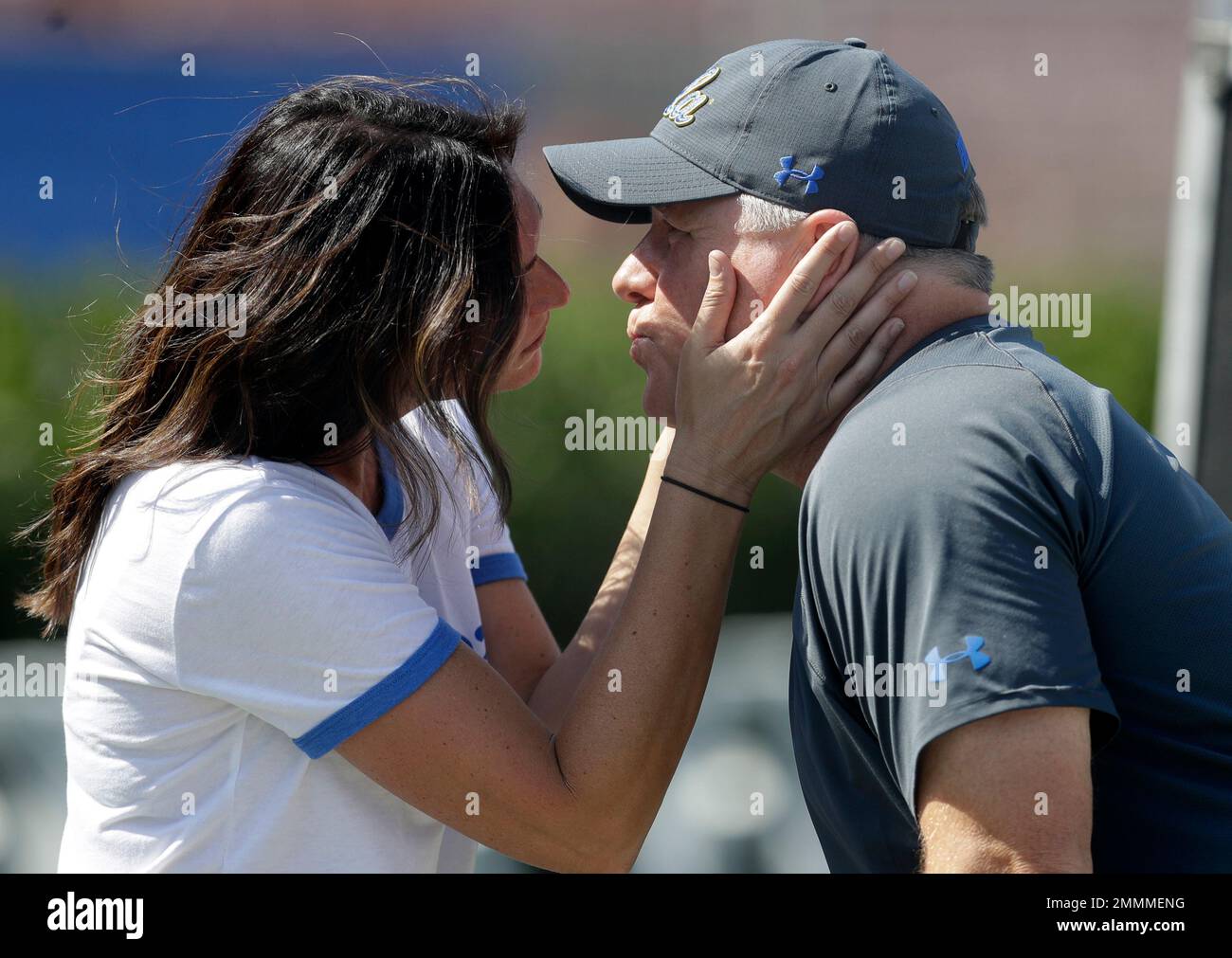 UCLA head coach Chip Kelly, right, gets a kiss from his girlfriend Jill Cohen before an NCAA college football game against Cincinnati Saturday, Sept. 1, 2018, in Pasadena, Calif. (AP Photo/Marcio Jose Sanchez) Stock Photo