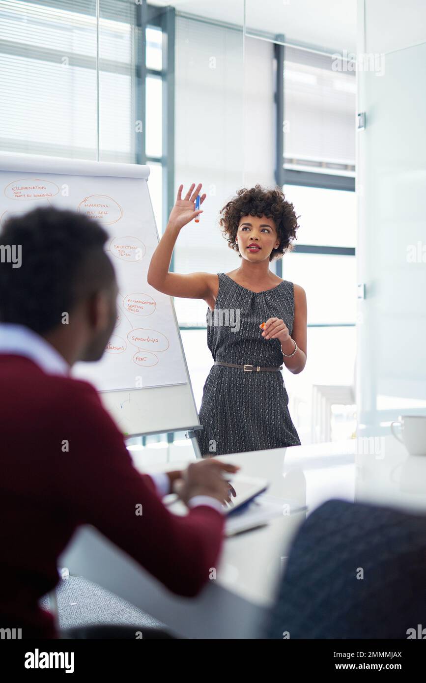 Shes spearheading this project. a young businesswoman giving a presentation in the boardroom. Stock Photo