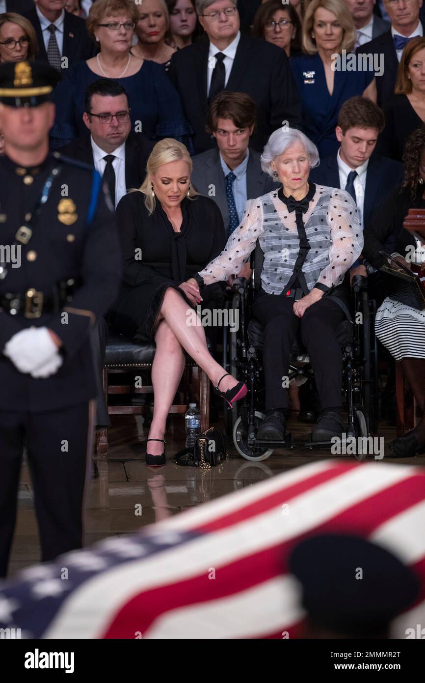 John McCain's daughter Meghan McCain, left, is comforted by his 106