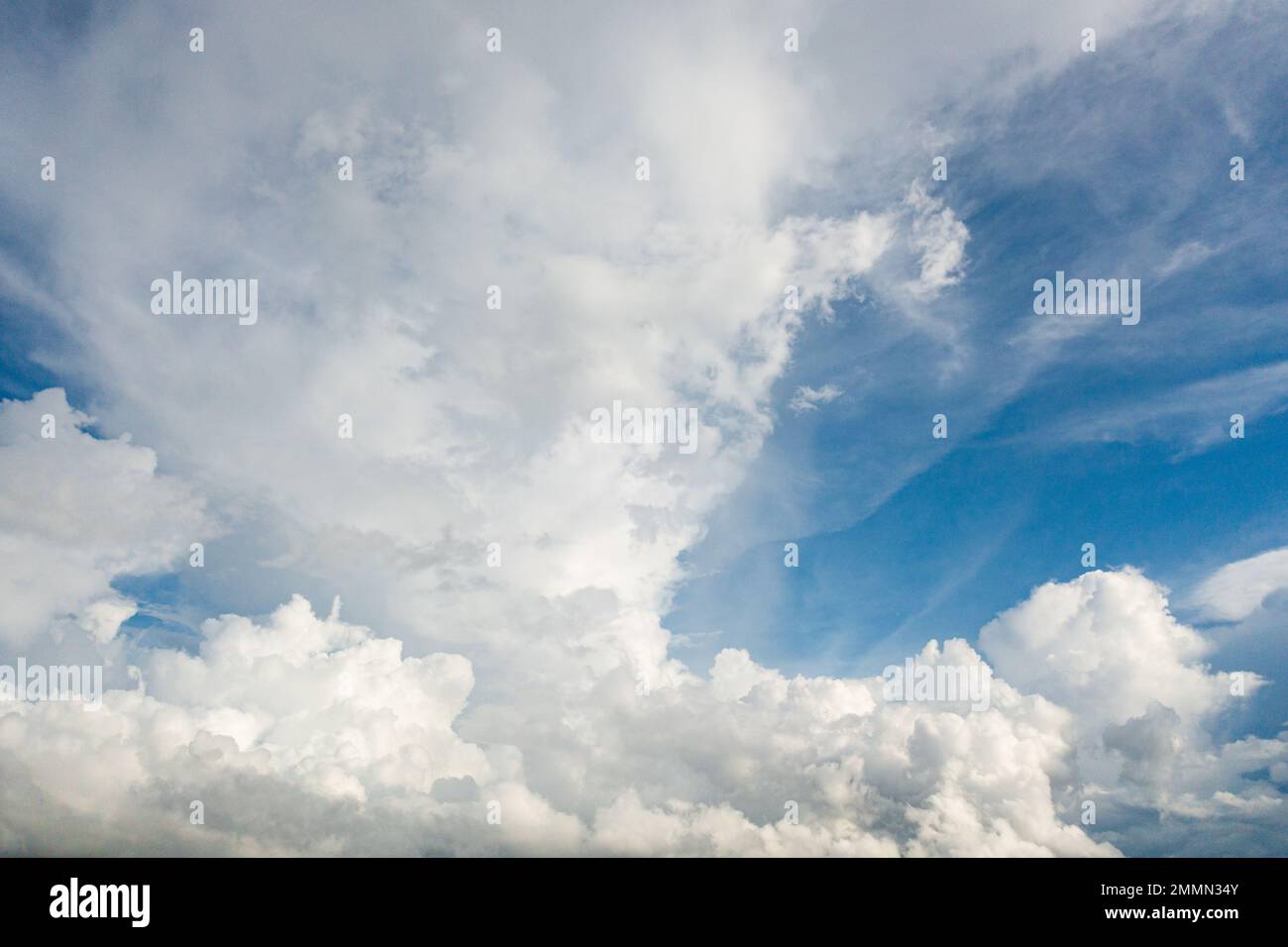 White, fluffy clouds in blue sky. Background from clouds. Stock Photo