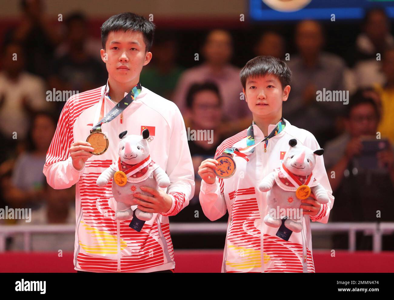 Wang Chuqin, left, and Sun Yingsha, right, of China stand