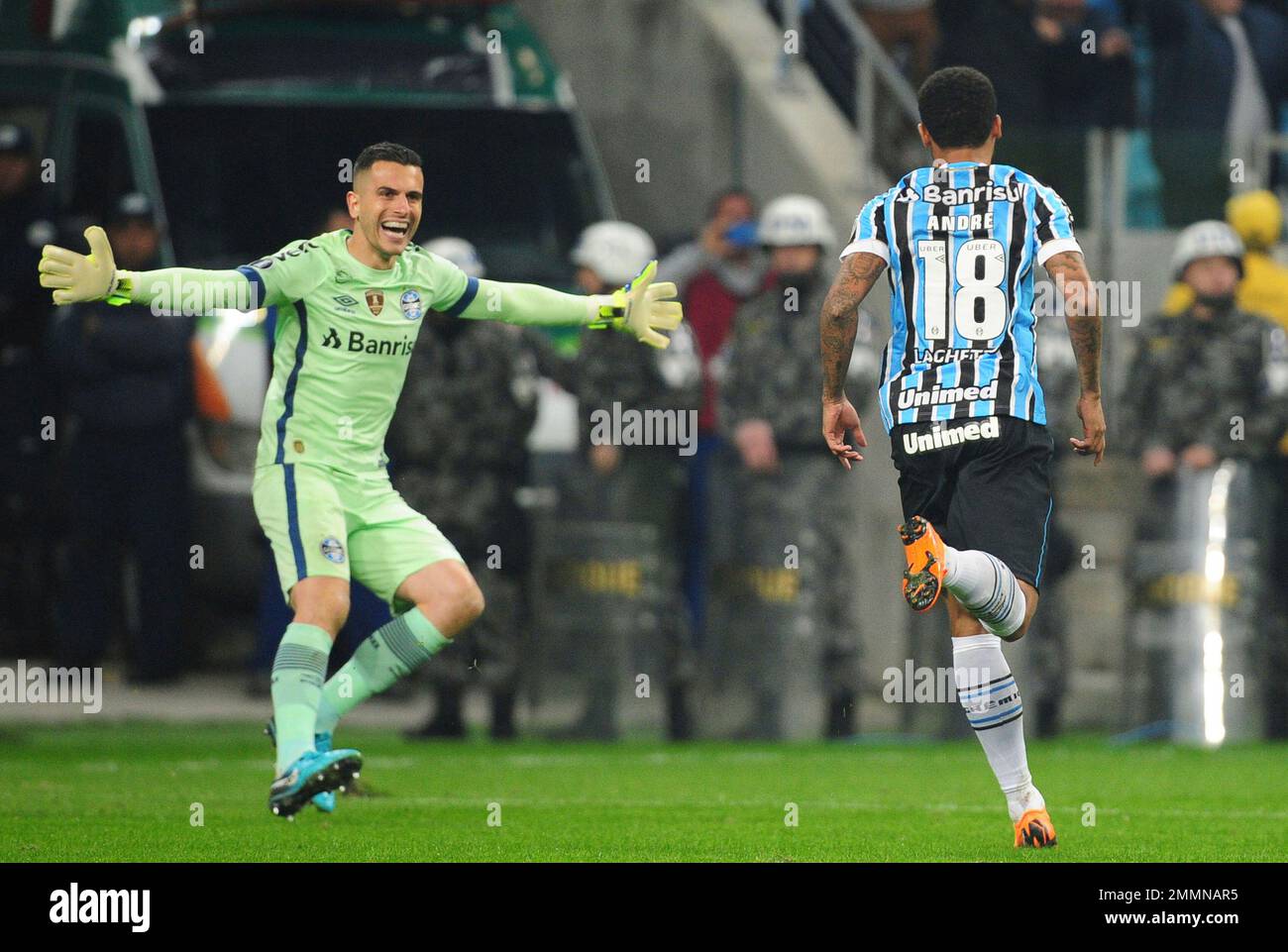 Andre of Brazil's Gremio, right, celebrates with goalkeeper Marcelo Grohe, after scoring from the penalty spot the victory goal against Argentina's Estudiantes in a Copa Libertadores soccer game, in Porto Alegre, Brazil, Tuesday, Aug. 28, 2018. Gremio won 5-3 in the penalty shootout and qualified for the quarterfinals. (AP Photo/Wesley Santos) Stock Photo