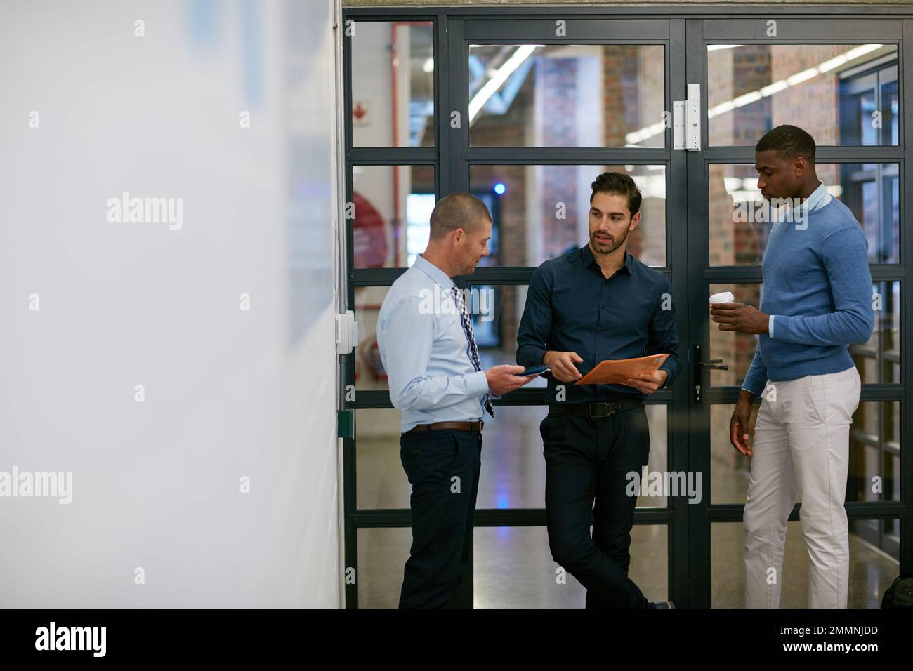 Discussing ideas. three businessmen in the office Stock Photo - Alamy