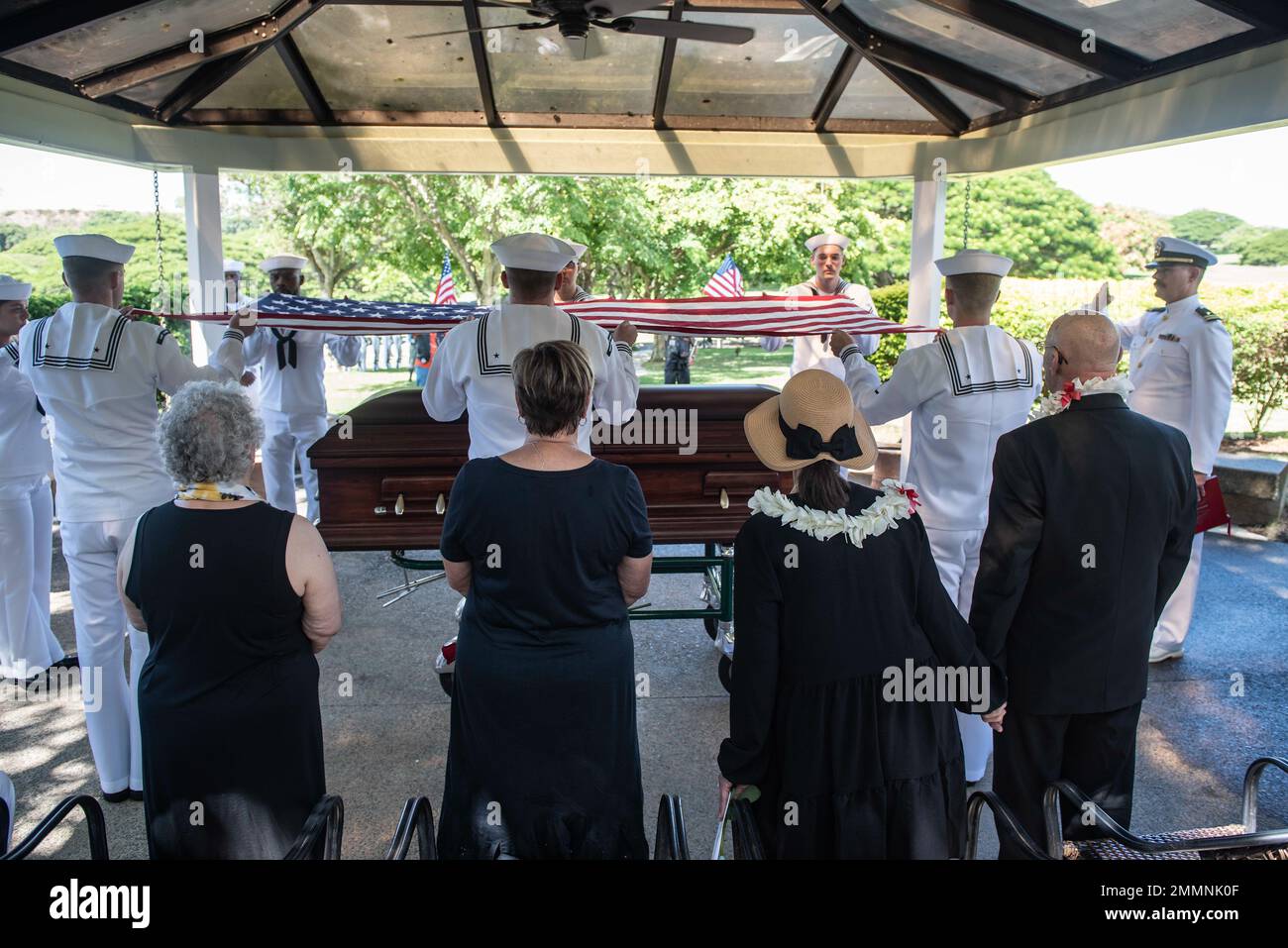 Family members of Petty Officer 1st Class Begin Corzatt stand during an ...
