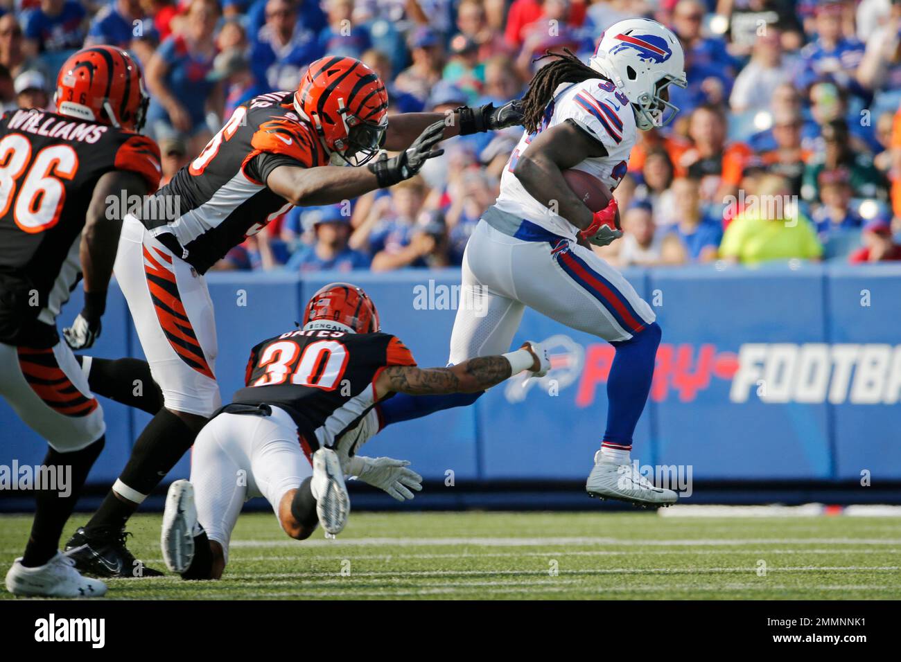 Buffalo Bills' Chris Ivory (33) runs away from Cincinnati Bengals' Carlos  Dunlap (96) and Jessie Bates (30) during the first half of a preseason NFL  football game Sunday, Aug. 26, 2018, in