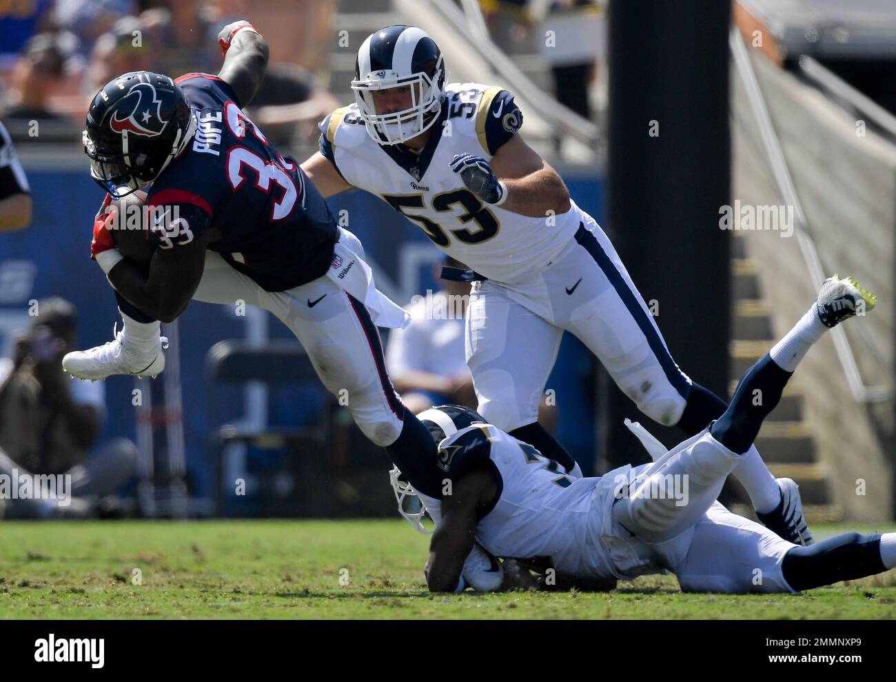 Houston Texans running back Troymaine Pope, left, breaks away from Los  Angeles Rams cornerback Taurean Nixon, defensive end Justin Lawler (53)  during the second half of an NFL preseason football game Saturday,