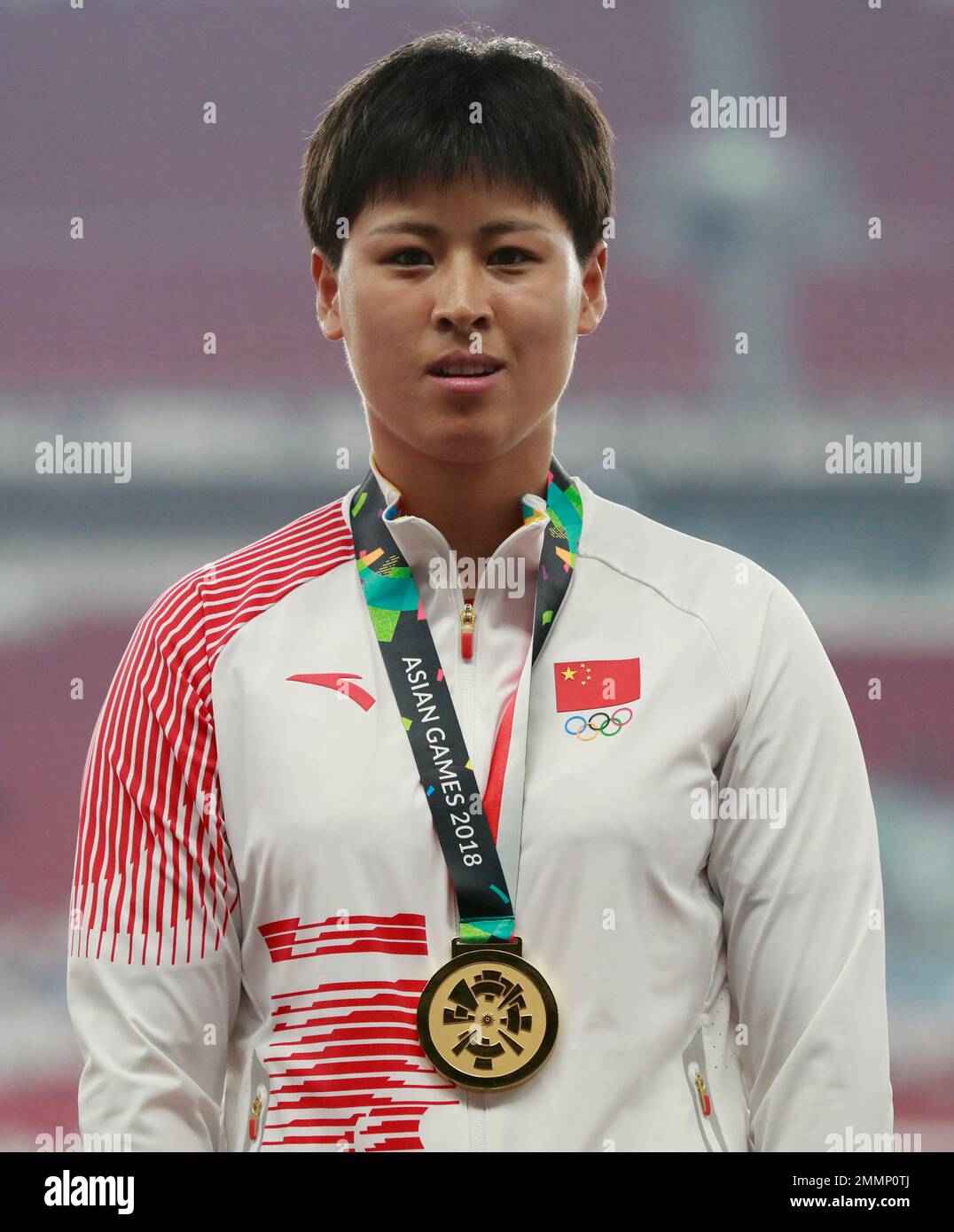 Women's hammer throw gold medalist China's Luo Na stands on the podium