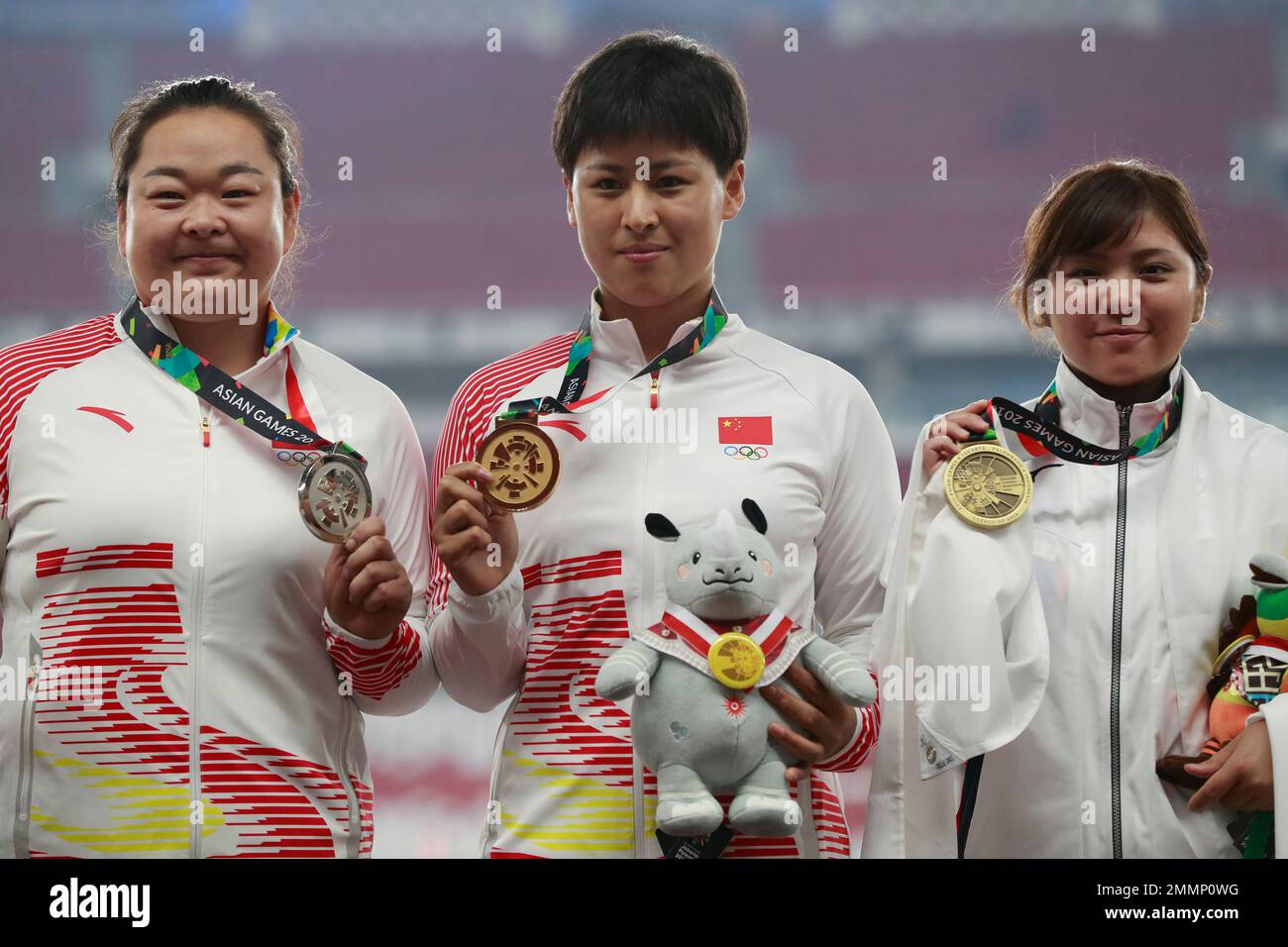 Women's hammer throw gold medalist China's Luo Na, centre, stands with