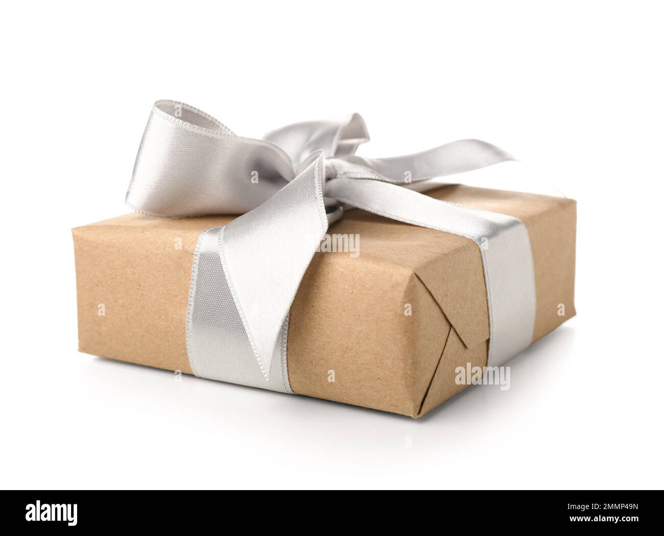 Gift box wrapped in craft paper with silk bow on white background Stock ...