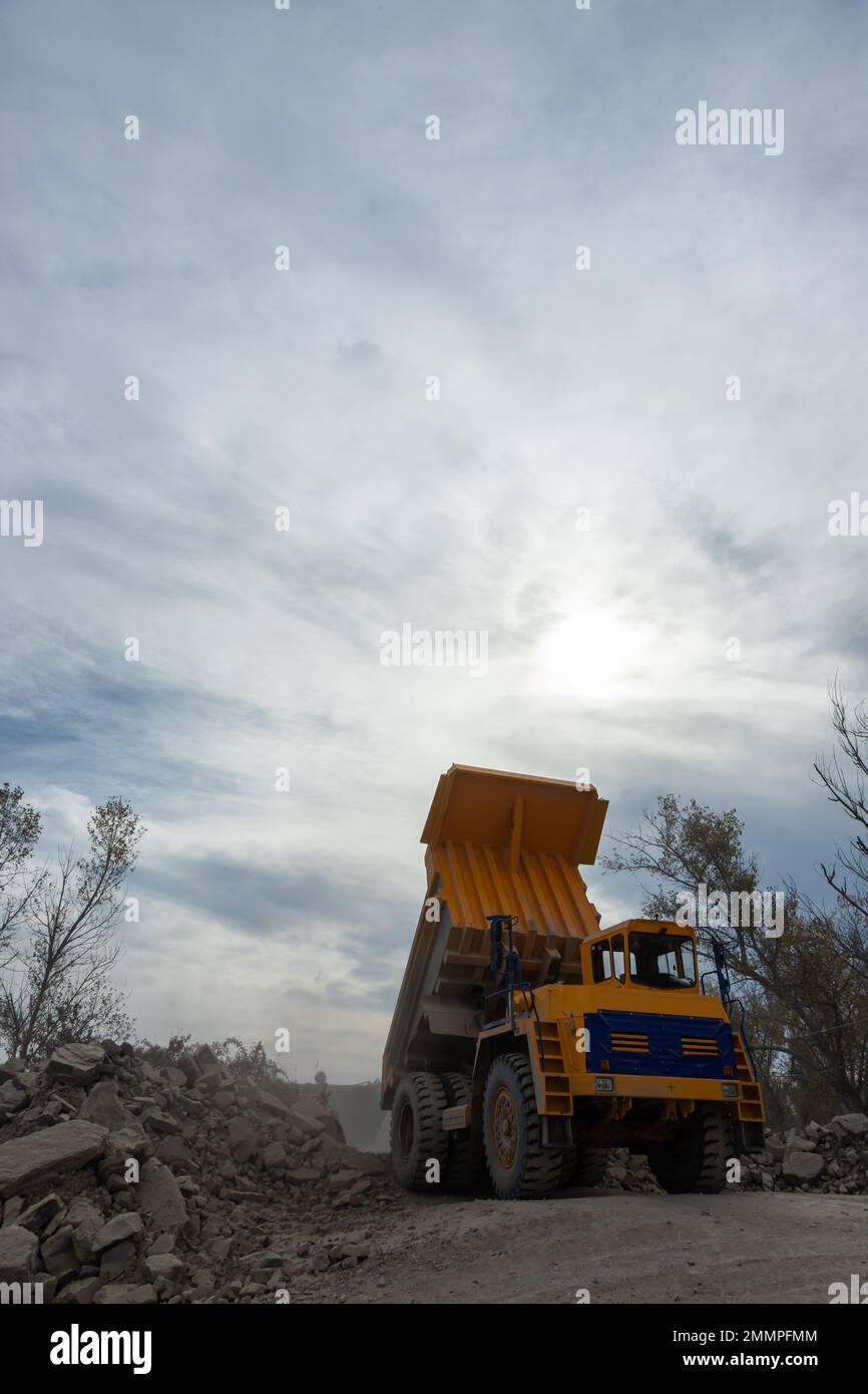 Large mining dump truck. Transport industry. Extraction of stone in an open pit. Stock Photo