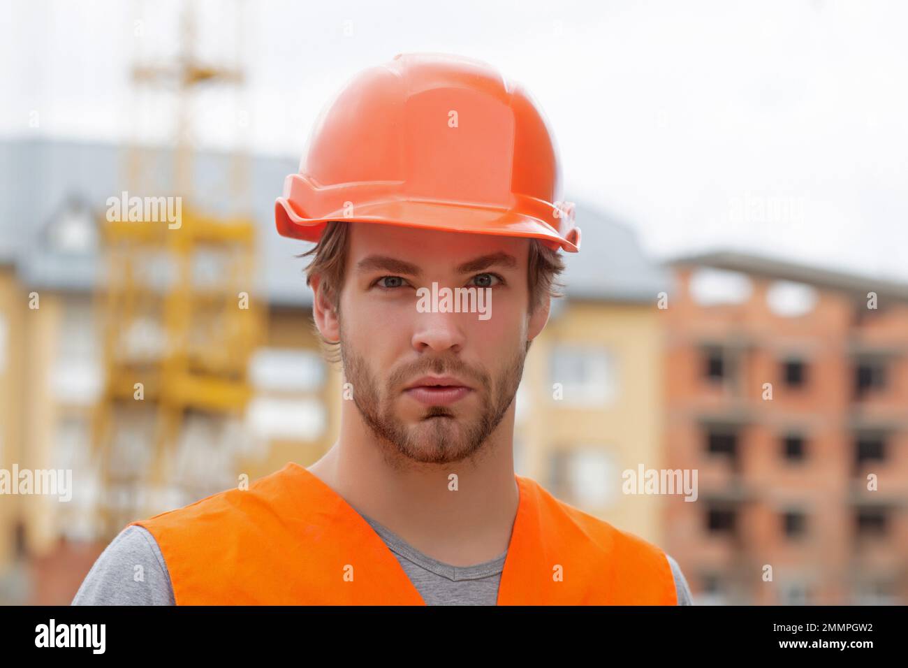Construction worker man in work clothes and a construction helmet
