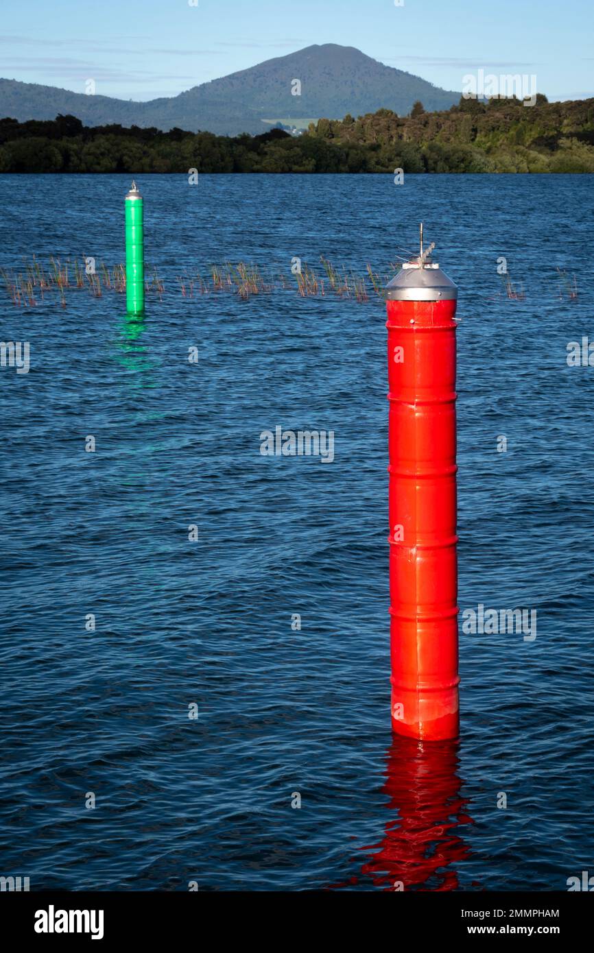 Red and green navigation markers either side of boating channel leading to Motuoapu Marina, Lake Taupo, North Island, New Zealand Stock Photo
