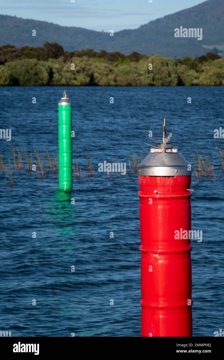 Red and green navigation markers either side of boating channel leading to Motuoapu Marina, Lake Taupo, North Island, New Zealand Stock Photo