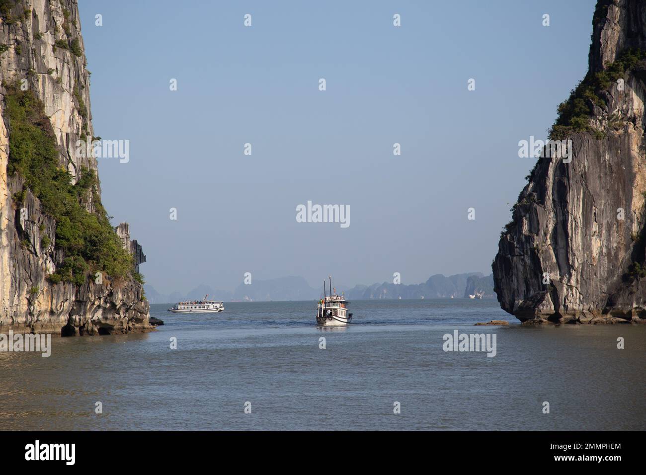 Ha Long Bay ( Halong bay ) View Over Landscape - boats float through the impressive landscape . Ha Long Bay , Vietnam Stock Photo