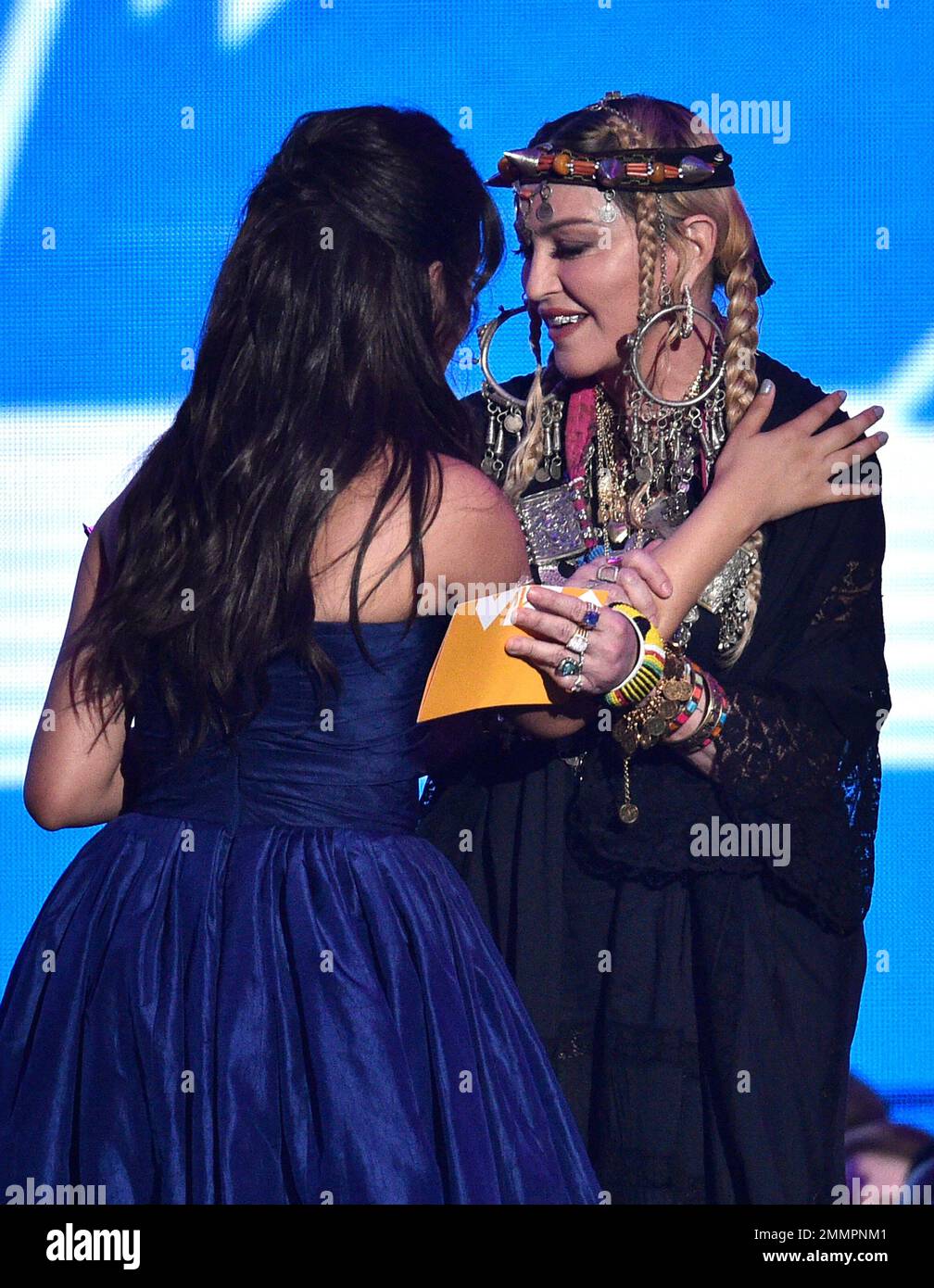 Camila Cabello, left, hugs presenter Madonna as she accepts the award