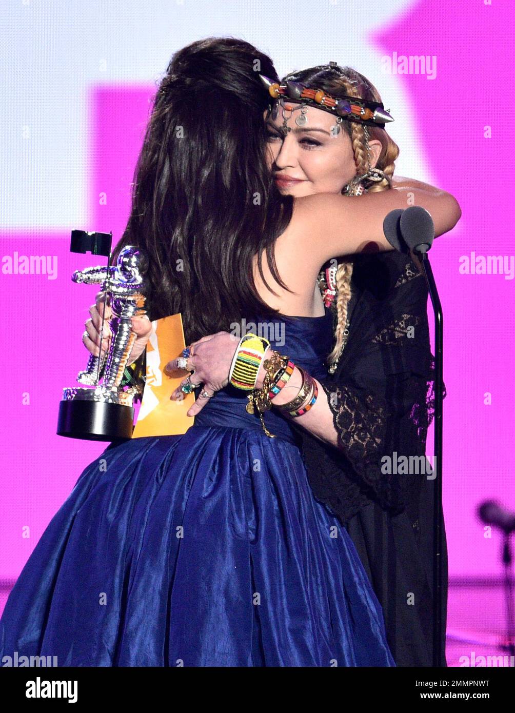 Camila Cabello, left, hugs presenter Madonna as she accepts the award
