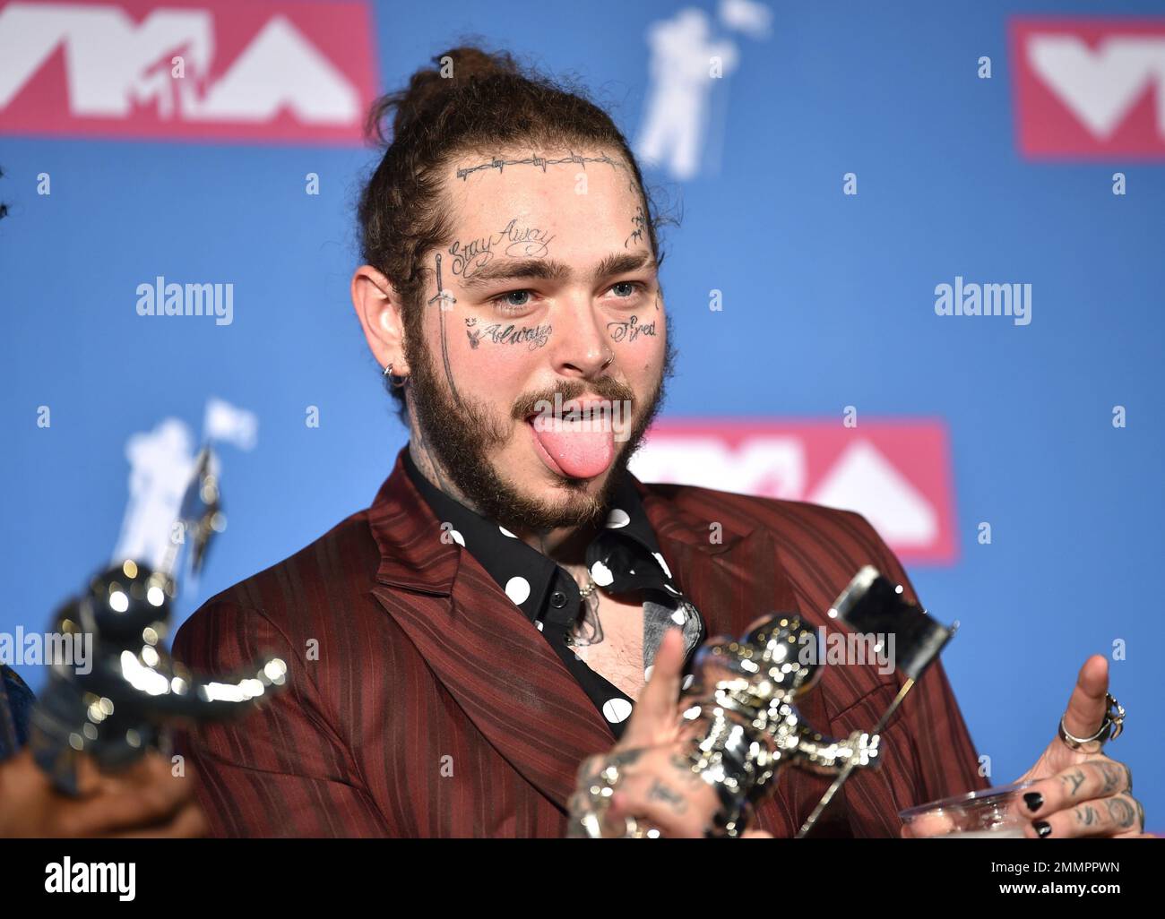 Post Malone poses with the award for song of the year for "Rockstar" in