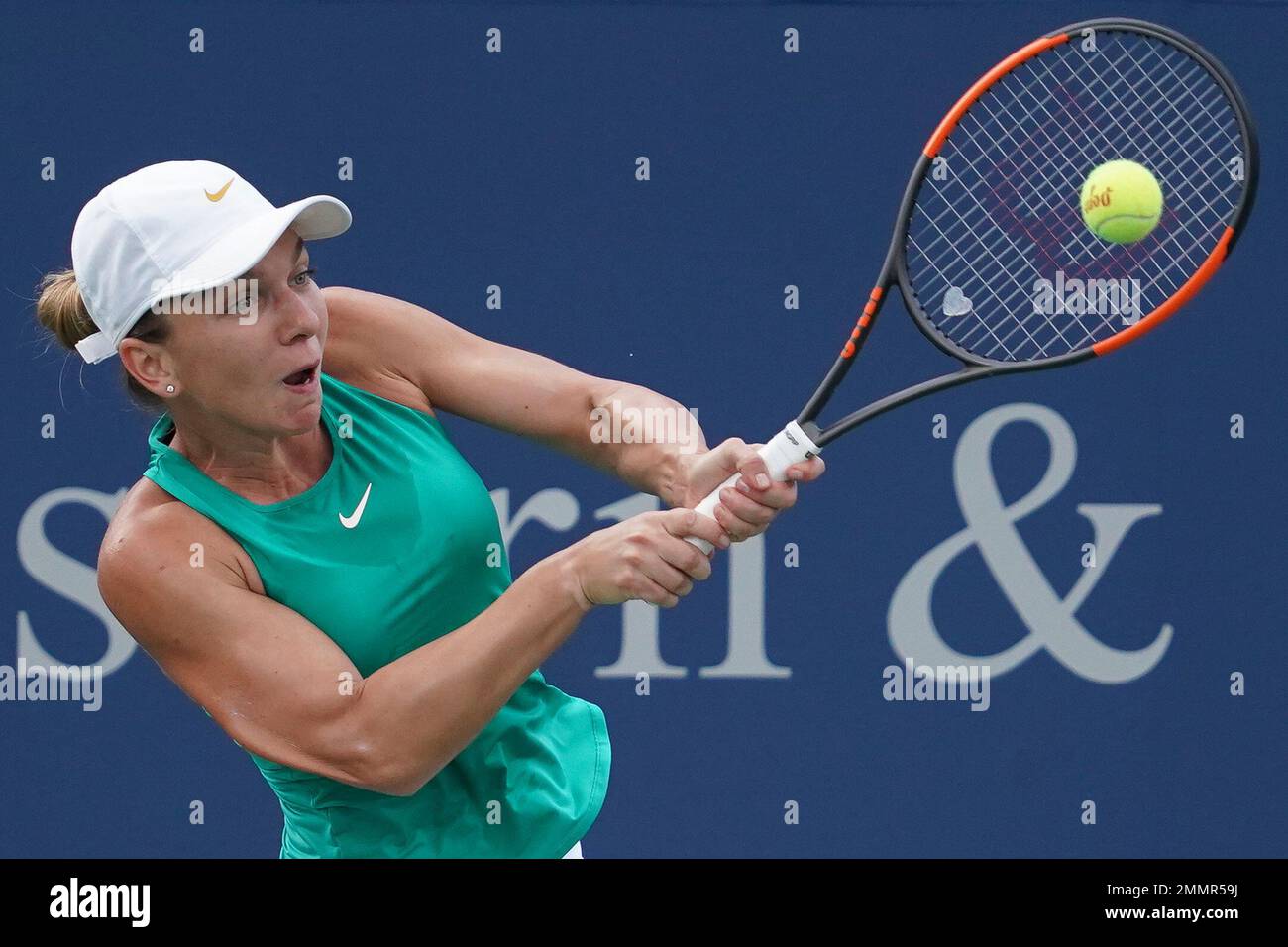 Simona Halep, of Romania, returns to Aryna Sabalenka, of Belarus