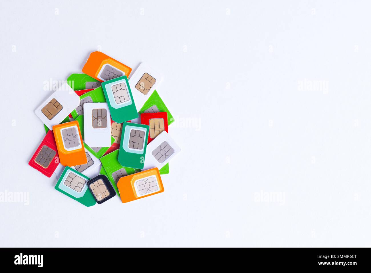 Heap of different used SIM cards for cellular communication on a white
