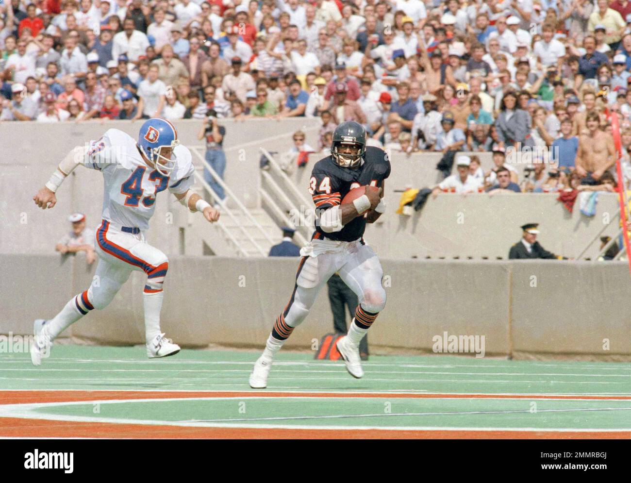 Chicago Bears' running back Walter Payton rushes away from Denver Broncos'  Steve Foley on a 40-yard gain in the third quarter of their game in  Chicago, Sept. 9, 1984. Bears won, 27-0. (