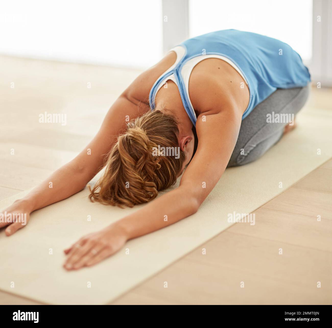 Yoga- part of her daily routine. a young woman doing yoga at home Stock ...