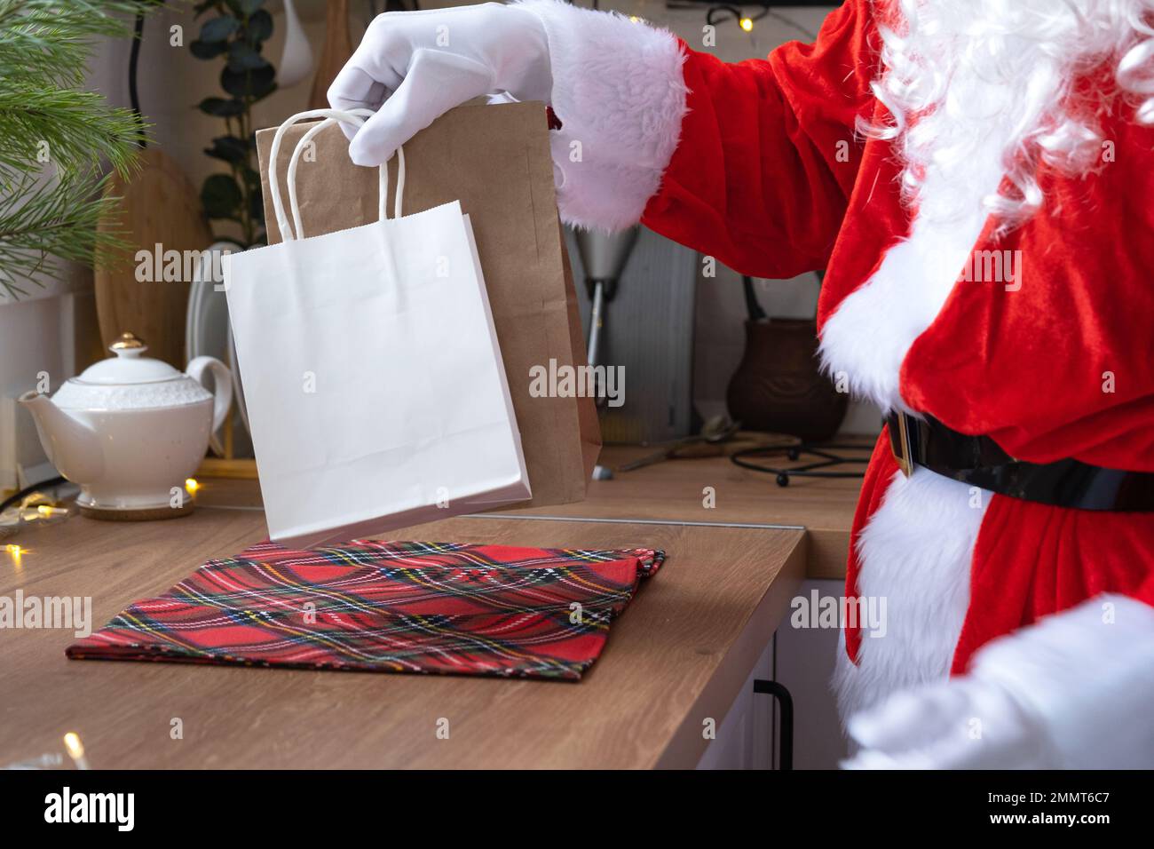 Santa Claus puts it on kitchen table and takes away paper bags with