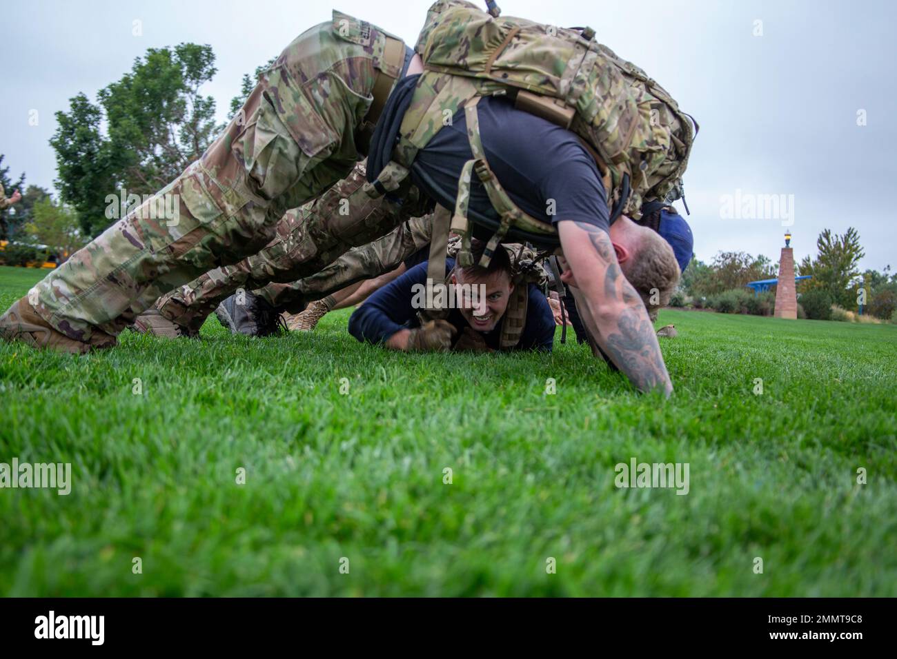A group of future Soldiers take turns low crawling under others holding a plank after finishing a GORUCK Event hosted by Special Operation Recruiting Battalion during a Special Forces Association Convention (SFACON), where 10th Special Forces Group (Airborne) Green Berets, Soldiers and retirees attended a four-day event held from September 21-24, 2022, in the Colorado Springs area including Fort Carson. GORUCK Events are multiple activities that are endurance based and led by current and former operators and those cadres help build a bridge between civilian and military worlds. Stock Photo