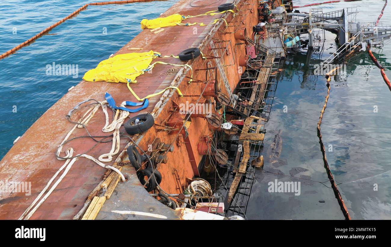 Drowned ship after the wreck. Overturned rusty oil tanker ship in