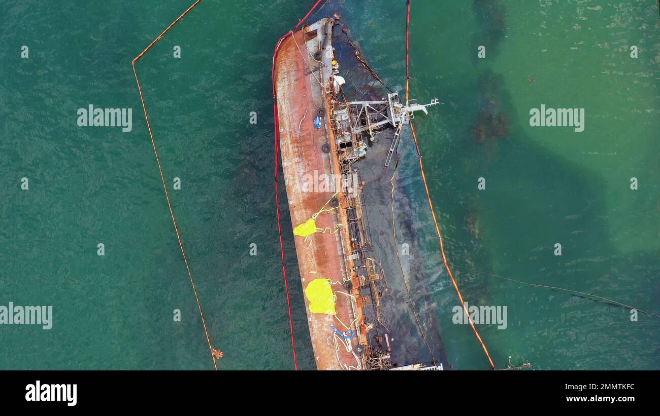 Aerial top view of broken rusty oil tanker ship in the shallow water