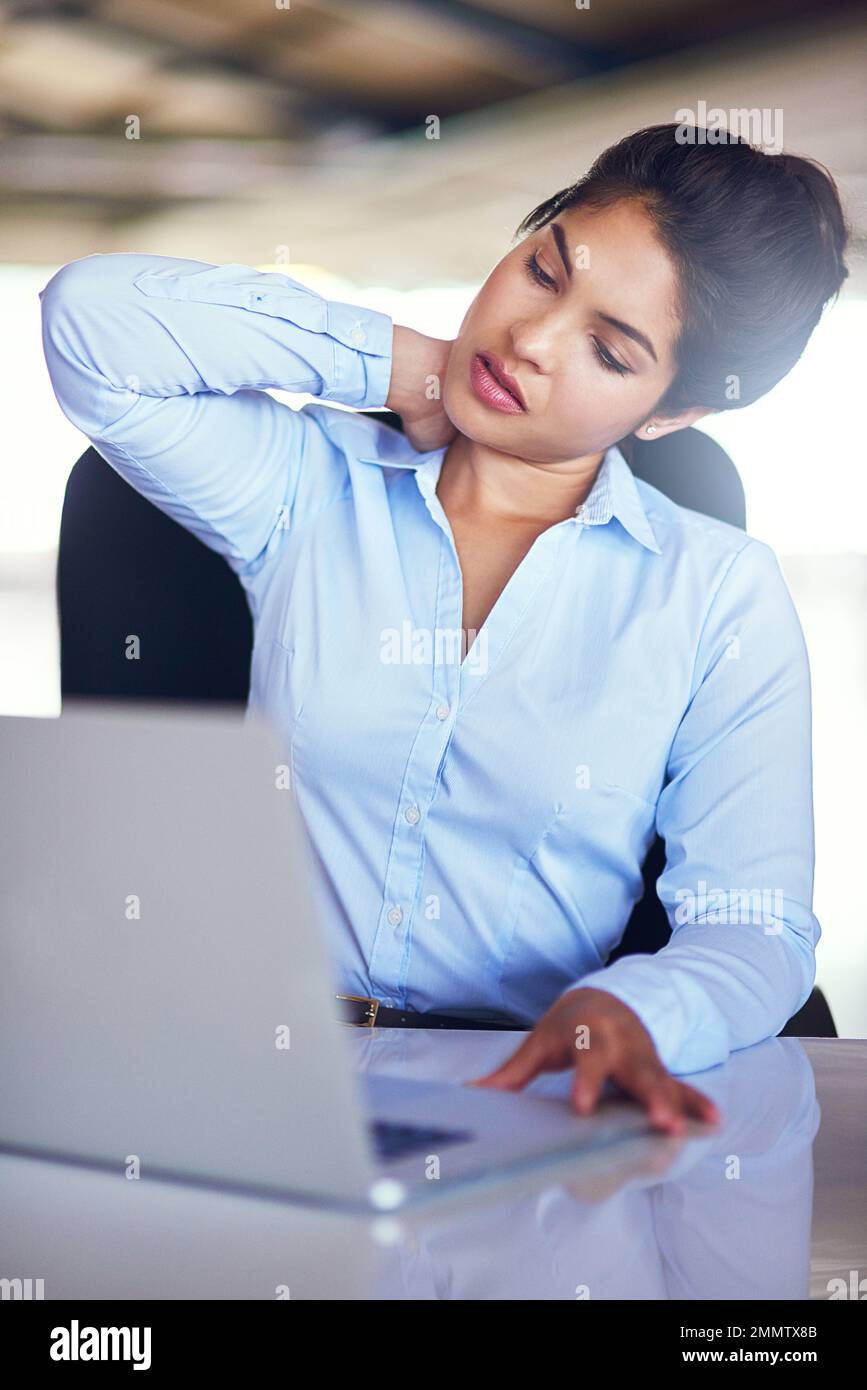 Too much tension...a young businesswoman suffering from neck pain while