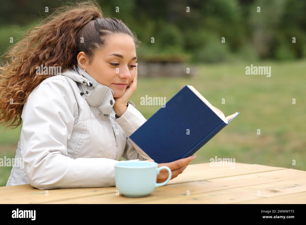 Hiker reading a book in a table in the mountain Stock Photo