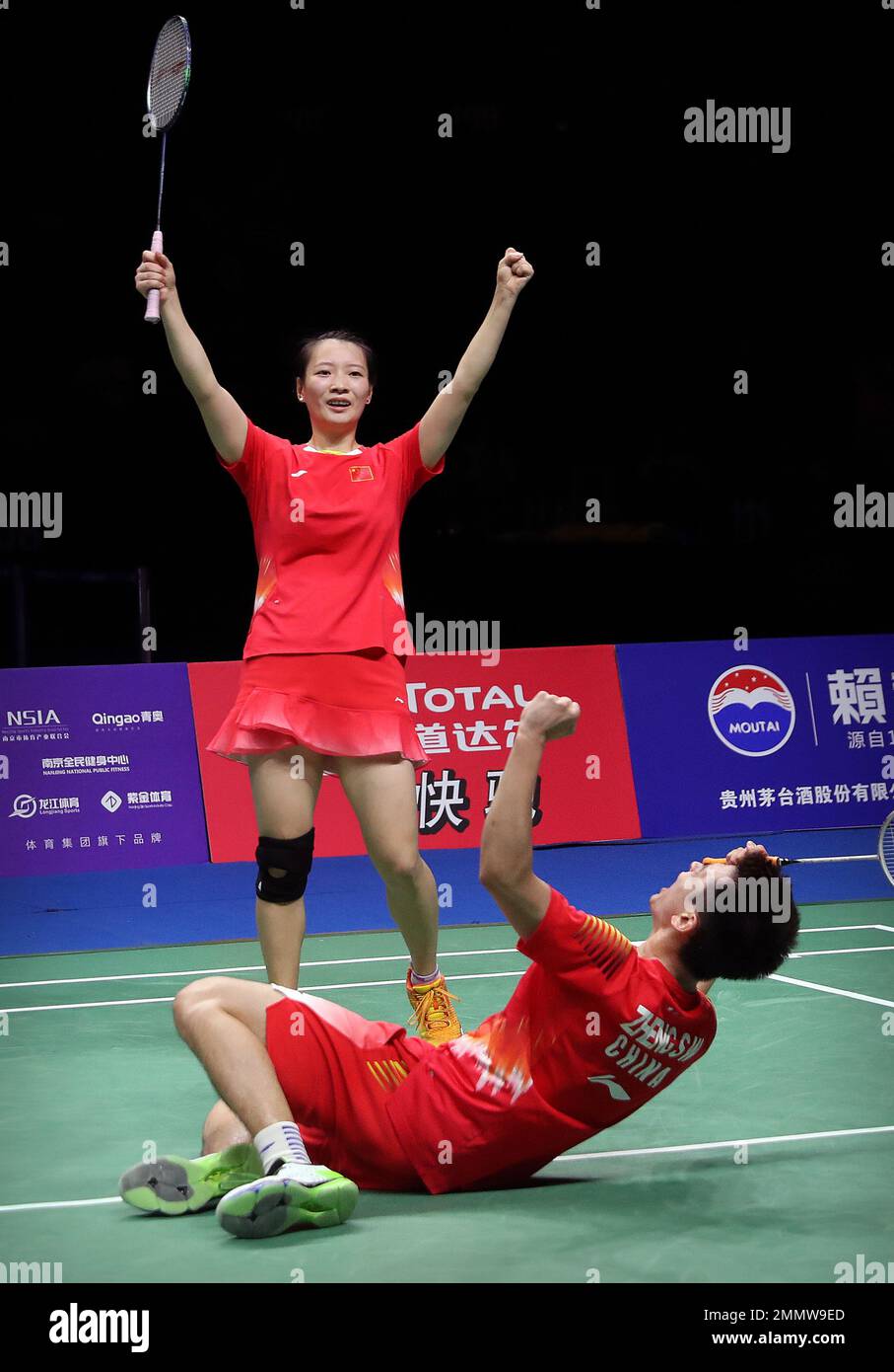 Huang Yaqiong, top, and Zheng Siwei of China react after beating Wang Yilyu and Huang Dongping of China in their mixed doubles badminton championship match at the BWF World Championships in Nanjing,