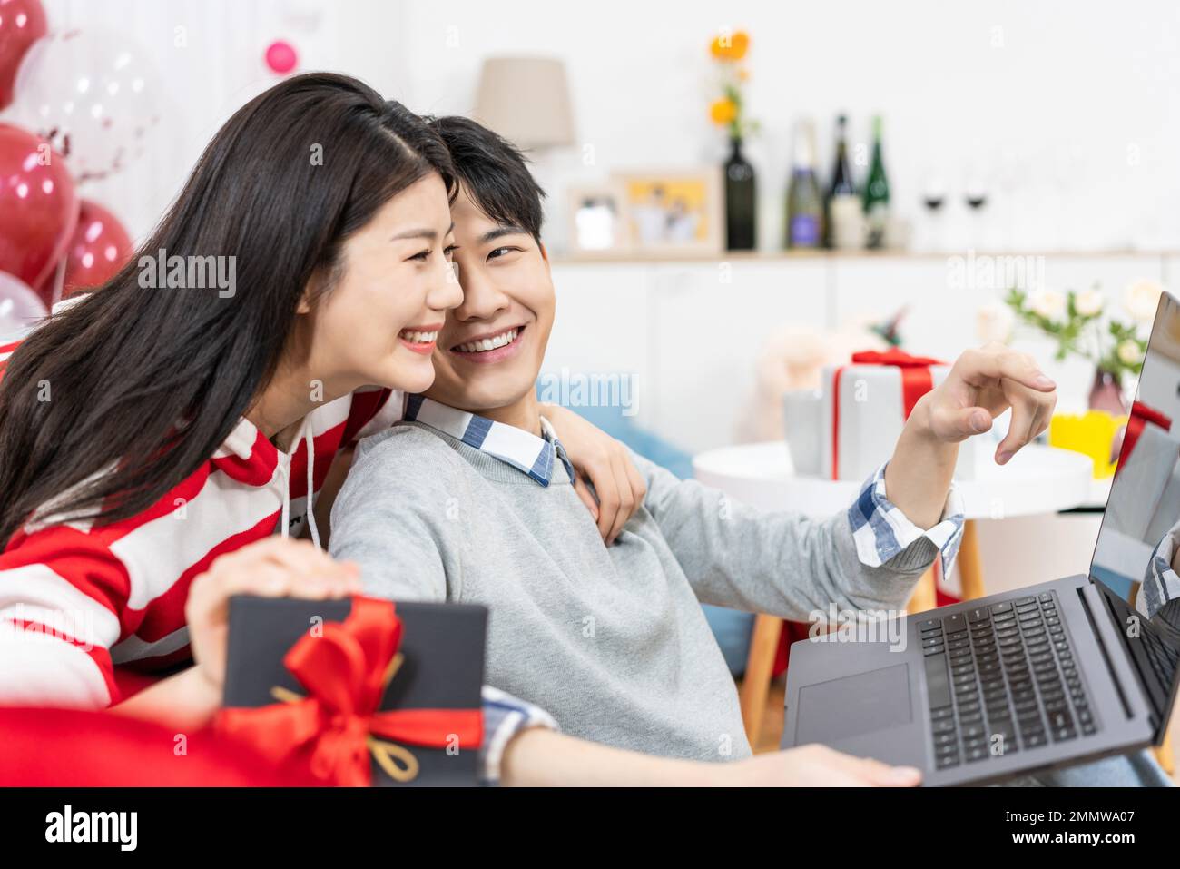 Young couples using laptop at home Stock Photo