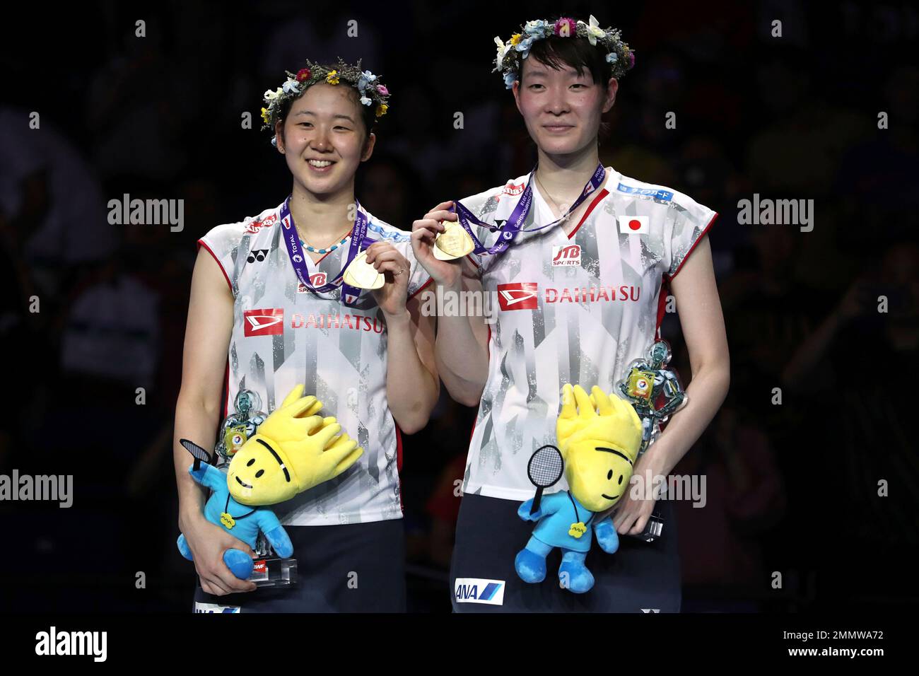 Wakana Nagahara, left, and Mayu Matsumoto of Japan stand with their medals after winning the womens badminton doubles championship match at the BWF World Championships in Nanjing, China, Sunday, Aug