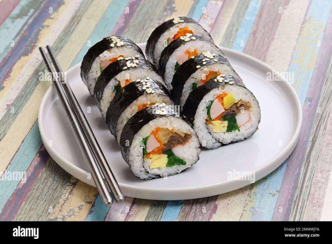 Gimbap is a Korean food consisting of rice and several ingredients seasoned with sesame oil and wrapped in nori seaweed. Stock Photo