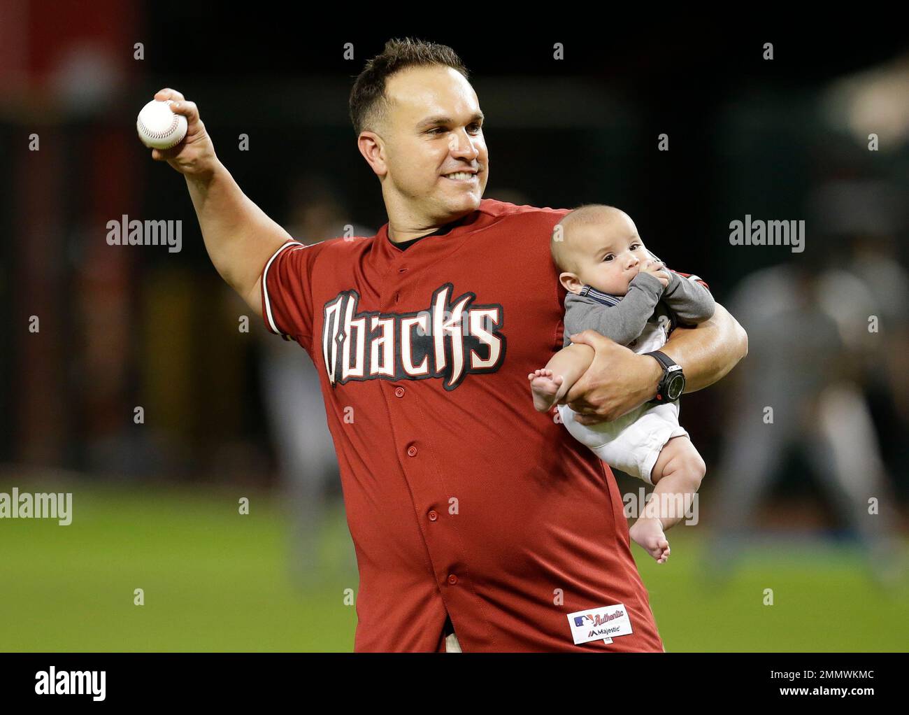 Former MLB player Miguel Montero and his son Miguel throw out the first  pitch before a baseball game between the Arizona Diamondbacks and the San  Francisco Giants, Thursday, Aug. 2, 2018, in