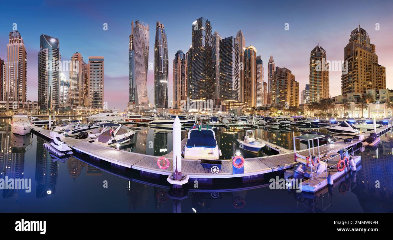 Dubai Marina panorama at night with luxury yacht, UAE Stock Photo