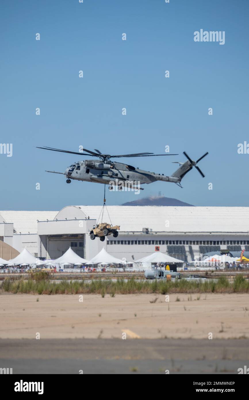 An CH-53E Super Stallion flies above the flight line during the Marine Air-Ground Task Force demonstration of the 2022 Marine Corps Air Station Miramar Air Show at MCAS Miramar, San Diego, California, Sept. 23, 2022. The MAGTF Demo displays the coordinated use of close-air support, armor, artillery and infantry forces and provides a visual representation of how the Marine Corps operates. The theme for the 2022 MCAS Miramar Air Show, “Marines Fight, Evolve and Win,” reflects the Marine Corps’ ongoing modernization efforts to prepare for future conflicts. Stock Photo