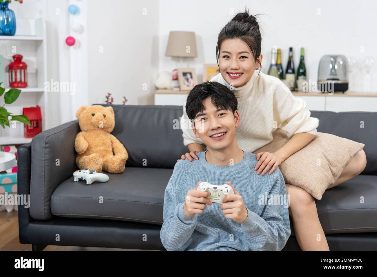 Young Cute Competitive Boyfriend Girlfriend Playing Video Games In Couch  Stock Photo, Picture and Royalty Free Image. Image 34313215.